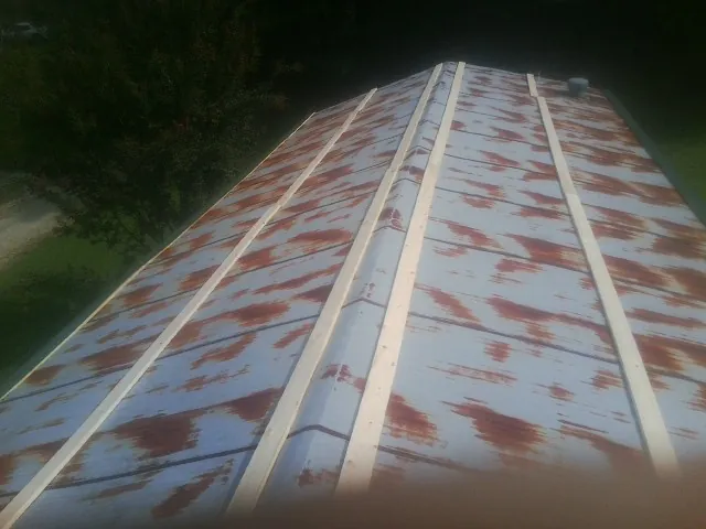 Rusted metal roof panels with new wood purlins before replacement — Storm Damage Roof Repair in New Holland by Roofing Brothers