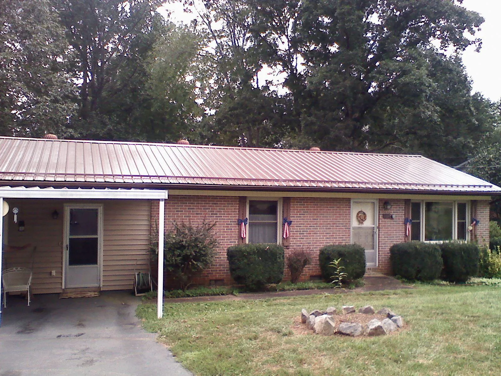 Bronze metal roof and carport on a brick ranch home — Roof Repair work by our crew in New Holland
